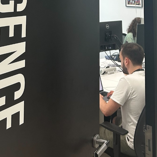 An FXC Intelligence employee through a doorway