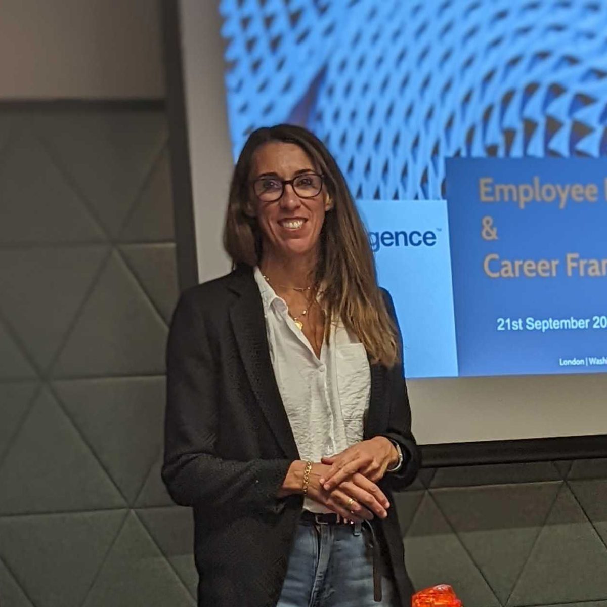A female FXC Intelligence employee presents a slide