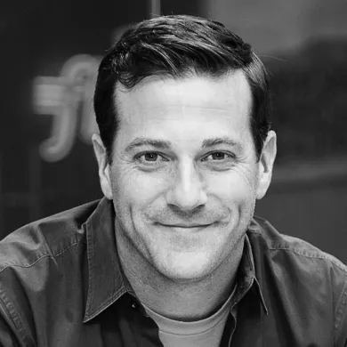 A headshot of Mike Massaro, CEO of Flywire.