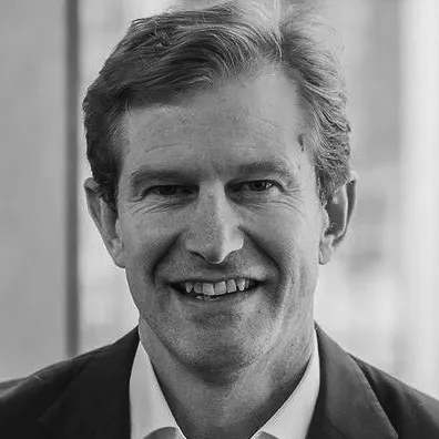 A headshot of Skander Malcolm, CEO of OFX